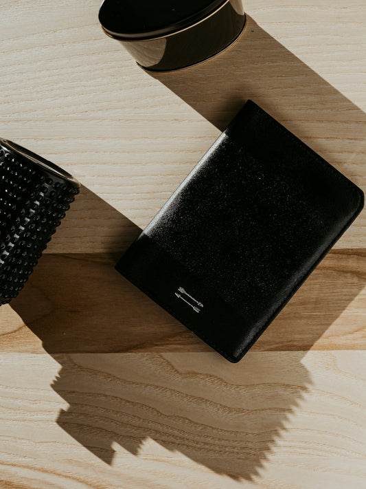 a black wallet on a wooden surface