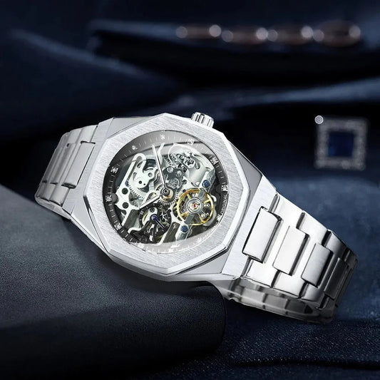 Silver luxury skeleton watch with visible mechanical movement and metal bracelet band