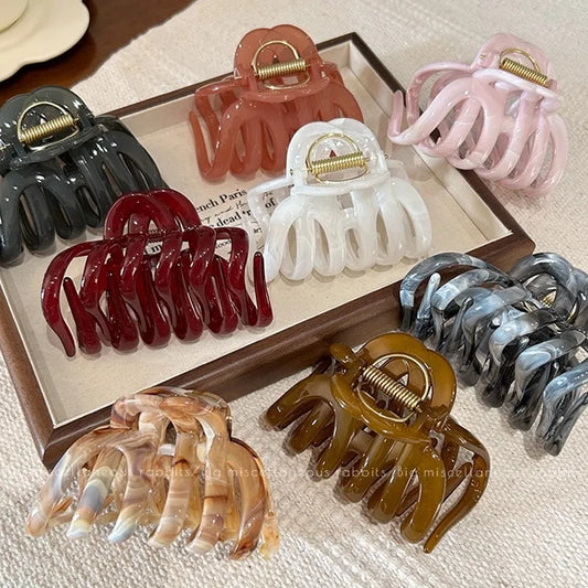 Set of LIVSY pumpkin hair claw clip in various colors including brown, pink, white, black, red, and marble patterns