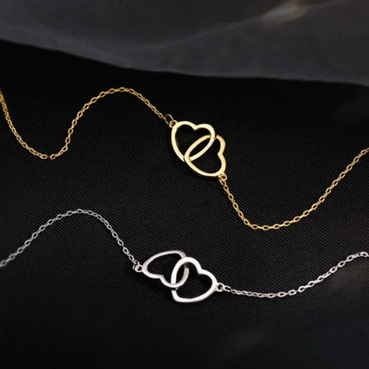 Gold and silver heart pendant necklace for women with interlocking heart design on delicate chains