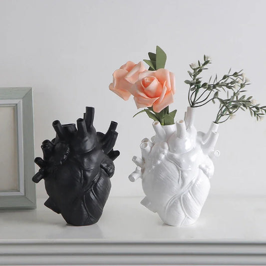 LIVSY heart shaped planter in black and white with flowers, designed to resemble an anatomical heart