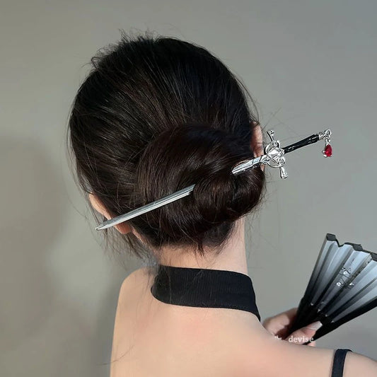 LIVSY antique sword hairpin securing a dark hair bun with a detailed sword design and red charm