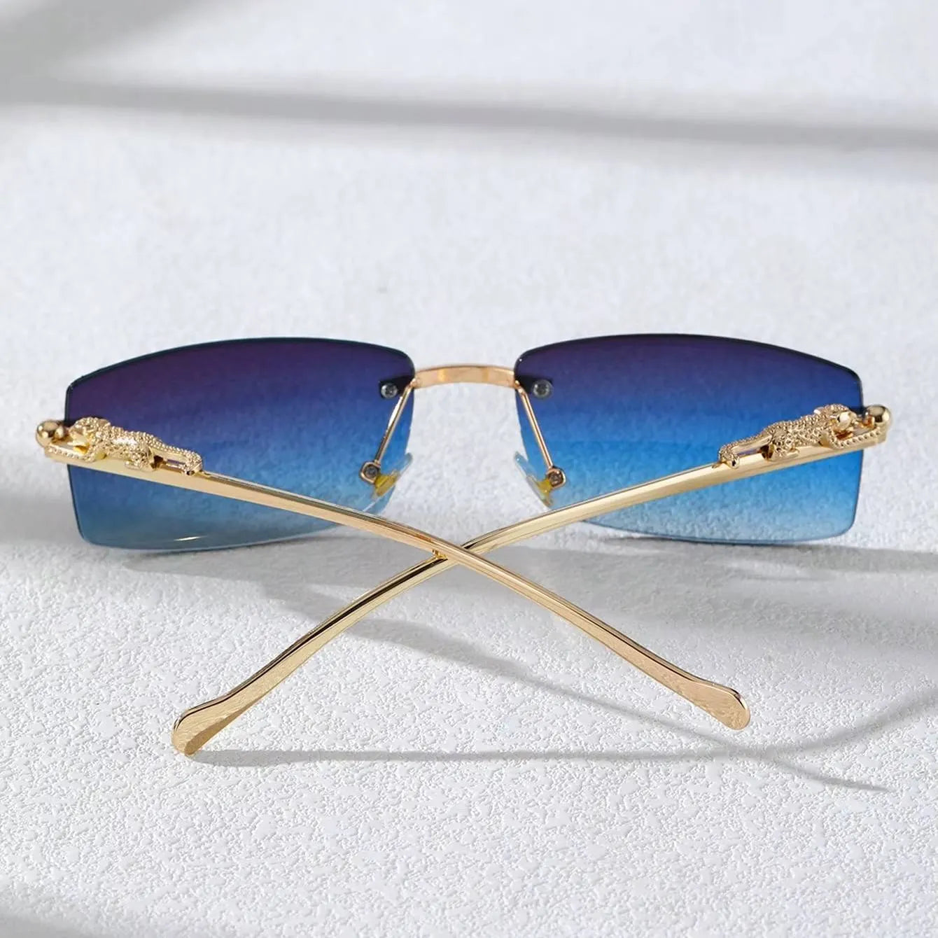 Chic rimless square glasses with gradient blue lenses and gold decorative arms by StorePilot