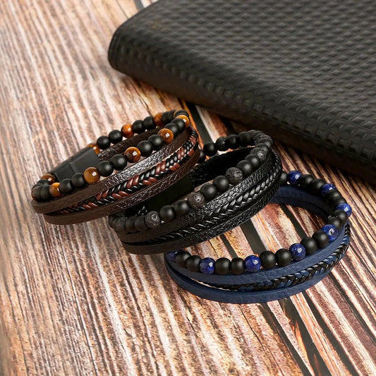 Tiger eye leather wrap bracelet displayed in brown, black, and blue color variations on a wooden surface
