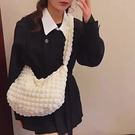 LIVSY white quilted tote bag for women with textured design worn by model in black outfit