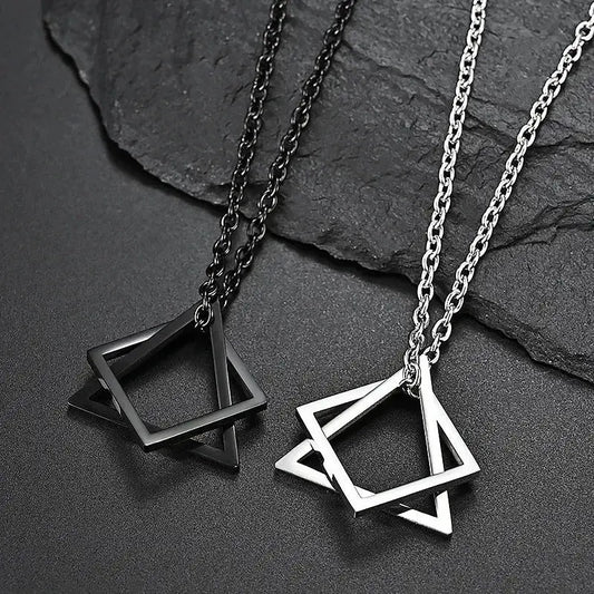 Black and silver titanium steel interlock choker necklaces with geometric star pendants on dark background