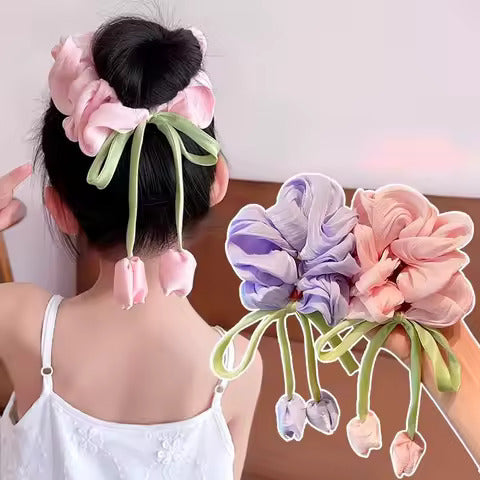 Korean style satin scrunchies in pink and purple with flower and ribbon details on girl’s hair bun